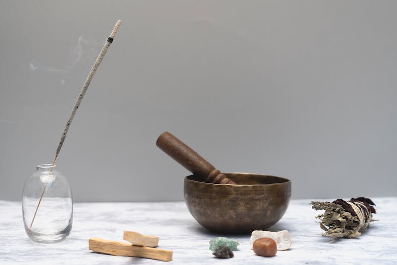 Spiritual self-care tools to clear energy. Incense, Palo Santo, crystals, singing bowl and sage.
